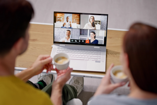 man and woman sitting in virtual meeting