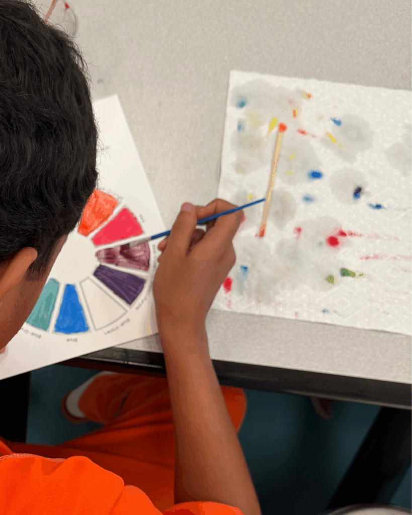 boy painting color wheel