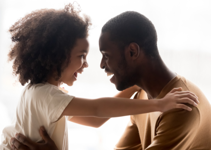 Dad and Daughter Smiling at Each Other