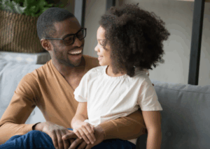 Dad and daughter smiling
