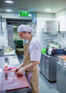 Teen boy working in a kitchen
